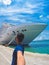 Portrait of a young black male tourist in front of a cruise ship on cloudy sky. African tourist on the beach trip