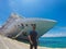 Portrait of a young black male tourist in front of a cruise ship on cloudy sky. African tourist on the beach trip