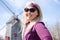 Portrait of a young blonde woman posing in front of the Eastham Windmill on Cape Cod