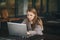 Portrait of young bored attractive woman at office desk, with laptop, feeling hopeless, lost motivation and inspiration