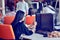 Portrait of young bored attractive woman at office desk, with laptop, looking for some good music