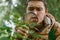 Portrait of young botanist with magnifying glass