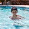 Portrait of young boy kid child eight years old having fun in swimming pool leisure activity square composition
