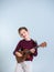 Portrait of a young boy playing the ukelele