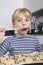 Portrait of young boy tasting spatula mix with cookie batter