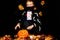 Portrait young boy wears face mask, costume dressed as halloween cosplay of scary dacula want to touch a jack`o pumpkin