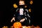 Portrait young boy wears face mask, costume dressed as halloween cosplay of scary dacula want to touch a jack`o pumpkin
