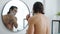 Portrait of young brunet shaving beard with razor in morning in bathroom