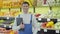 Portrait of young brunette Caucasian man in uniform posing in grocery shop. Positive employee holding folder and smiling