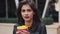 Portrait of young brunette woman with coffee looking into the camera. Laughing cheerful portrait of successful business