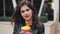 Portrait of young brunette woman with coffee looking into the camera. Laughing cheerful portrait of successful business