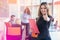 Portrait of young business woman at modern startup office interior showing thumbs up