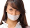 Portrait of young business woman with taped mouth