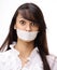 Portrait of young business woman with taped mouth