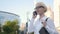 Portrait of Young Business Woman Typing Text Message On Phone Outdoors