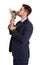 Portrait of young businessman kissing gold trophy cup on white