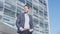 Portrait of young businessman relaxing in the city - business man in suit