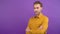 Portrait of young calm confident man with folded hands isolated on purple background. 4K