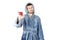 Portrait of young caucasian bearded man in blue bathrobe raises glass of red wine isolated on white background