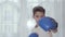 Portrait of young Caucasian boy boxing at camera. Cute schoolboy in boxing gloves showing his skills. Going in for