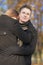 portrait of young caucasian handsome man protecting his girlfriend standing outdoor