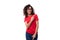 portrait young caucasian leader woman with black curly hair dressed in a red basic t-shirt
