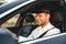 Portrait of young caucasian male taxi driver wearing uniform and