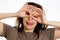 Portrait of a young Caucasian woman makes a grimace. White background. The concept of April Fools` Day