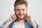 Portrait of young cheerful merry guy making funny face fooling looking at camera showing tongue over white background.