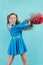 Portrait of young cheerleader girl from cheerleading group. turquoise background