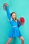 portrait of young cheerleader girl from cheerleading group. turquoise background.