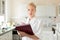 Portrait of young, confident female health care professional taking notes during inventory in scientific laboratory or