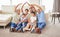 Portrait of a young couple ensuring that their familys home is covered. Hispanic parents and grandparents smiling and