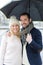 Portrait of a young couple on holidays under the rain