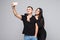 Portrait of young couple lady guy couple make take selfies isolated grey background