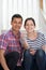 Portrait Of Young Couple Sitting On Stairs Holding Keys To New H