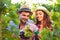 Portrait young couple in vineyard during harvest season