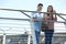 Portrait Of Young Couple Walking To Work Over Bridge