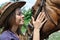 Portrait of young cowgirl and horse