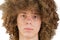 Portrait of a young curly European man with long curly hair and a defiant gaze looks into the frame close-up. very lush male hair