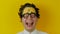 Portrait of young curly laughing man, funny and cheerfully human emotion, on yellow wall background