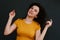 Portrait of young cute emotional caucasian female on grey background.