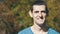 Portrait of a Young Cute Guy Looking in the Lens and Smiling in Nature in the Summer