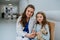 Portrait of young doctor with his little patient at pediatrics.