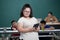 Portrait of young down syndrome girl holding tablet computer in hand with happiness and self-confident