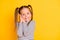 Portrait of young dreamy happy smiling girl child kid just wake-up  on yellow color background