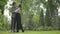 Portrait of a young embracing loving couple having rest in a park. Date couple outdoors.