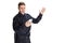 Portrait of young excited man, policeman officer wearing black uniform using phone isolated on white background. Concept