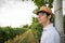 Portrait of a young farmer in his vineyard looking forward, confident gaze on the future