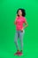 Portrait of young female African American talking for mobile phone and rejoice. Black woman with curly hair in pink